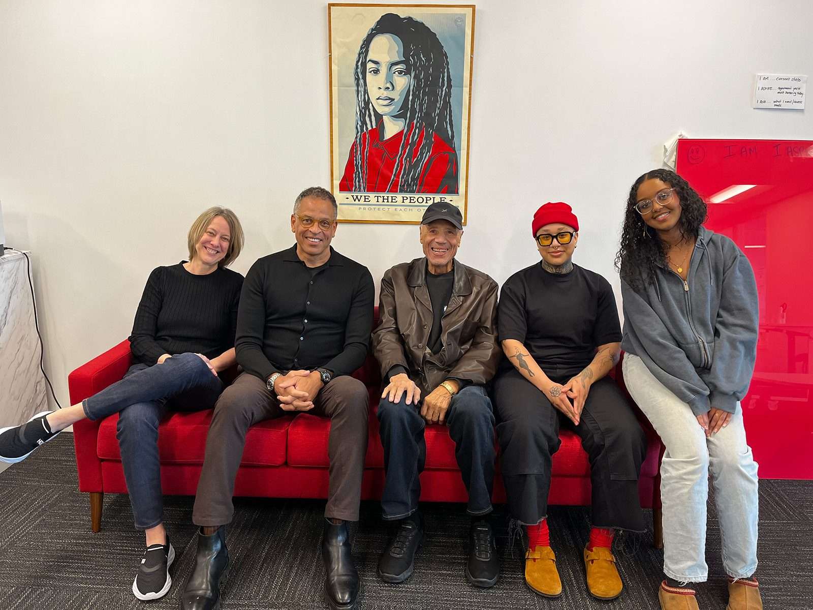 A group of people sitting on a couch, including Lenny Wilkens and Dr. Ben Danielson.